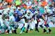 Oct 20, 2013; Miami Gardens, FL, USA; Miami Dolphins running back Lamar Miller (26) runs past Buffalo Bills outside linebacker Manny Lawson (91) during the second quarter at Sun Life Stadium. Mandatory Credit: Steve Mitchell-USA TODAY Sports