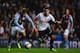 Erik Lamela tussles with Joe Bennett of Aston Villa during the Capital One Cup match.