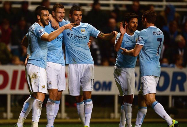Hi-res-186357606-edin-dzeko-of-manchester-city-celebrates-scoring-their_crop_north