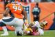 DENVER, CO - OCTOBER 27: Quarterback Robert Griffin III #10 of the Washington Redskins reacts after being hit by defensive tackle Terrance Knighton #94 of the Denver Broncos during a game at Sports Authority Field Field at Mile High on October 27, 2013 in Denver, Colorado. The Broncos beat the Redskins 45-21. (Photo by Dustin Bradford/Getty Images)