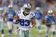 DETROIT, MI - OCTOBER 27: Terrance Williams #83 of the Dallas Cowboys scores on a sixty yard pass from Tony Romo #9 in the fourth quarter of the game against the Detroit Lions at Ford Field on October 27, 2013 in Detroit, Michigan. The Lions defeated the Cowboys 31-30. (Photo by Leon Halip/Getty Images)