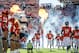 DENVER, CO - OCTOBER 27: Quarterback Peyton Manning #18 of the Denver Broncos runs out onto the field as flames ignite during player introductions before a game against the Washington Redskins at Sports Authority Field Field at Mile High on October 27, 2013 in Denver, Colorado. (Photo by Dustin Bradford/Getty Images)