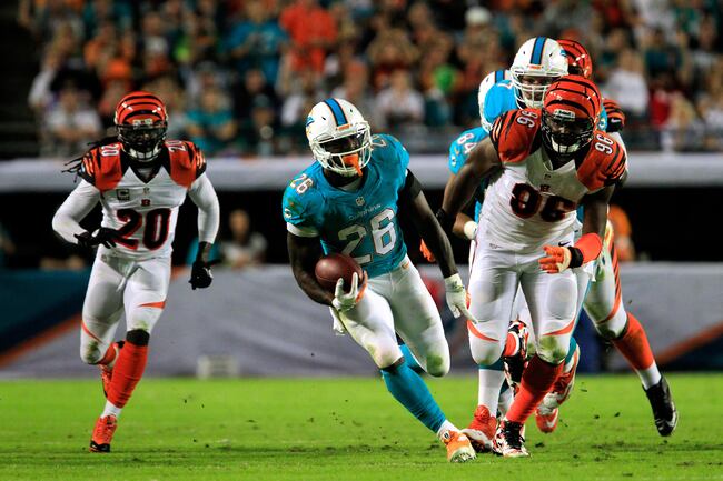 Hi-res-186502846-lamar-miller-of-the-miami-dolphins-runs-with-ball-under_crop_north