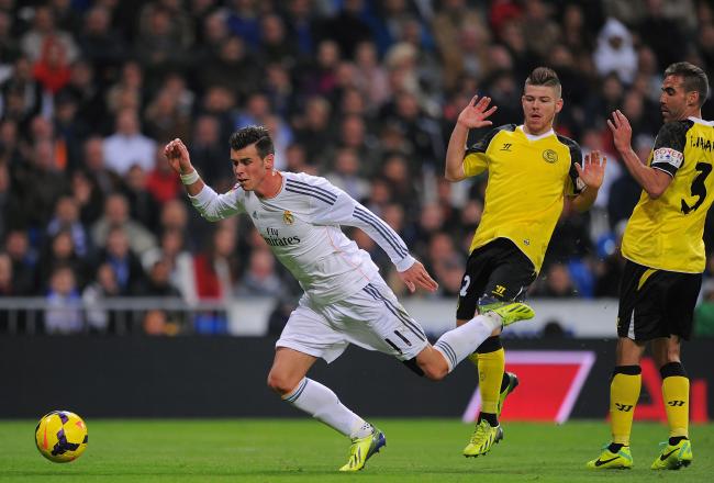 Hi-res-186358176-gareth-bale-of-real-madrid-cf-falls-after-a-tackle-from_crop_north
