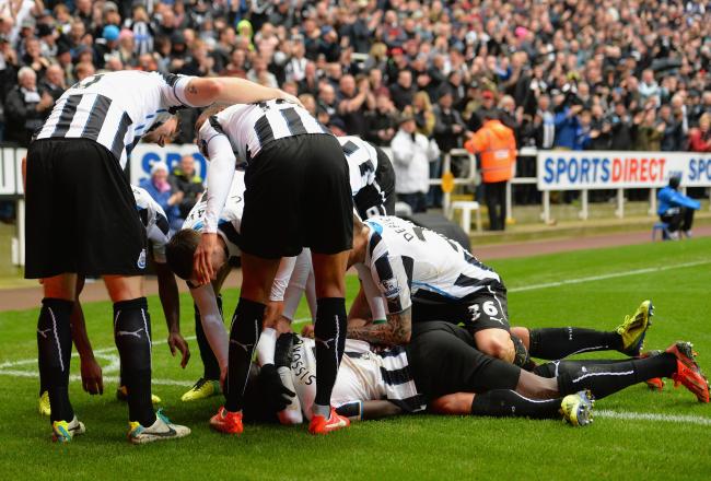 Hi-res-186620169-yoan-gouffran-of-newcastle-united-is-mobbed-by-his-team_crop_north