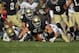 SOUTH BEND, IN - OCTOBER 29: Troy Niklas #58 of the Notre Dame Fighting Irish moves to recover a fumble by Marcus Thomas #34 of the Navy Midshipmen as Bo Snelson #4 crashes in at Notre Dame Stadium on October 29, 2011 in South Bend, Indiana. Notre Dame defeated Navy 56-14. (Photo by Jonathan Daniel/Getty Images)