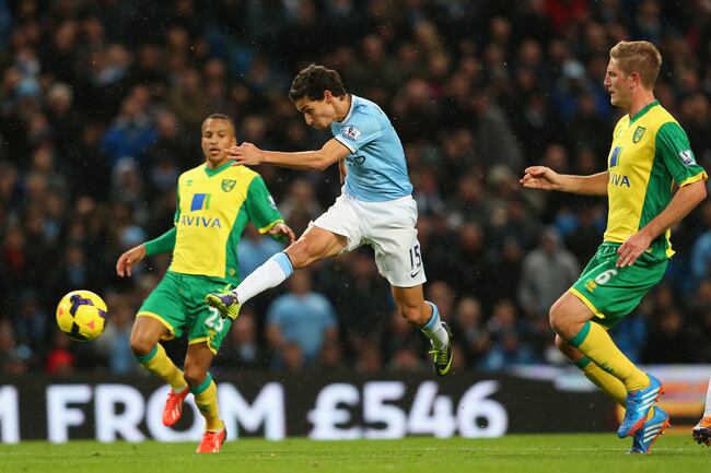 Hi-res-186633379-jesus-navas-of-manchester-city-shoots-at-goal-during_crop_north