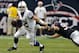 HOUSTON, TX - DECEMBER 16: Andrew Luck #12 of the Indianapolis Colts avoids the tackle by J.J. Watt #99 of the Houston Texans in the second half at Reliant Stadium on December 16, 2012 in Houston, Texas. Texans win 29-17 to clinch the AFC South. (Photo by Bob Levey/Getty Images)