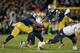 Nov 2, 2013; South Bend, IN, USA; Navy Midshipmen wide receiver Shawn Lynch (87) is tackled by Notre Dame Fighting Irish linebacker Jaylon Smith (9) and cornerback Bennett Jackson (2) in the fourth quarter at Notre Dame Stadium. Notre Dame won 38-34. Mandatory Credit: Matt Cashore-USA TODAY Sports