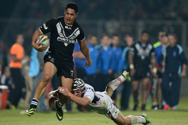 Hi-res-186572010-roger-tuivasa-scheck-of-new-zealand-slips-the-tackle-of_crop_north