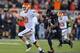 LUBBOCK, TX - NOVEMBER 2: Quarterback Clint Chelf #10 of the Oklahoma State Cowboys breaks a long run for a touchdown against the Texas Tech Red Raiders during game action on November 2, 2013 at AT&T Jones Stadium in Lubbock, Texas. Oklahoma State won the game 52-34. (Photo by John Weast/Getty Images)