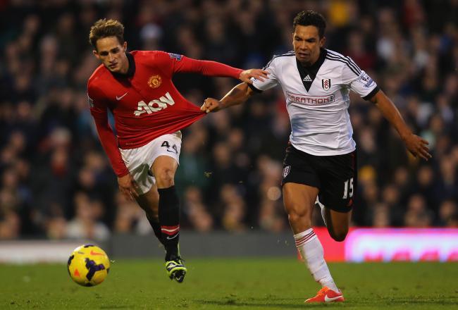 Hi-res-186629129-kieran-richardson-of-fulham-pulls-on-the-shirt-of-adnan_crop_north