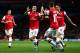 LONDON, ENGLAND - OCTOBER 01: Mesut Oezil #11of Arsenal is congratulated by teammate Aaron Ramsey #16 after scoring the opening goal during UEFA Champions League Group F match between Arsenal FC and SSC Napoli at Emirates Stadium on October 1, 2013 in London, England. (Photo by Paul Gilham/Getty Images)