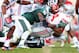 September 29, 2012; East Lansing, MI, USA; Ohio State Buckeyes running back Carlos Hyde (34) is tackled by Michigan State Spartans linebacker Chris Norman (10) and defensive end William Gholston (2) during the second half of a game at Spartan Stadium. Ohio State won 17-16 Mandatory Credit: Mike Carter-USA TODAY Sports