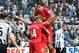 NEWCASTLE UPON TYNE, UNITED KINGDOM - OCTOBER 19: Steven Gerrard of Liverpool celebrates with Jordan Henderson (L) and Luis Suarez (up) after scoring his 100th goal for the club from the penalty spot during the Barclays Premier League game between Newcastle United and Liverpool at St James' Park on October 19, 2013 in Newcastle upon Tyne, England. (Photo by Ian Horrocks/Getty Images)