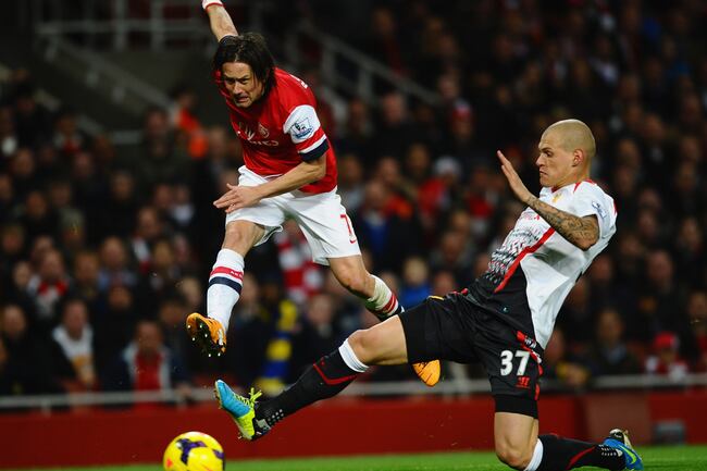 Hi-res-186633168-martin-skrtel-of-liverpool-tackles-tomas-rosicky-of_crop_north