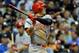 Aug 15, 2013; Milwaukee, WI, USA; Cincinnati Reds center fielder Shin-Soo Choo hits a single in the 8th inning during the game against the Milwaukee Brewers at Miller Park. Mandatory Credit: Benny Sieu-USA TODAY Sports