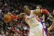 HOUSTON, TX - NOVEMBER 07: Dwight Howard #12 of the Houston Rockets fighst for the ball with Nick Young #0 and Chris Kamen #9 of the Los Angeles Lakers during the game at Toyota Center on November 7, 2013 in Houston, Texas. NOTE TO USER: User expressly acknowledges and agrees that, by downloading and or using this photograph, User is consenting to the terms and conditions of the Getty Images License Agreement. (Photo by Scott Halleran/Getty Images)