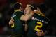 ST HELENS, ENGLAND - NOVEMBER 02: Daly Cherry-Evans (centre) of Australia celebrates scoring a try during the Rugby League World Cup: Group A match between Australia and Fiji at Langtree Park on November 2, 2013 in St Helens, England. (Photo by Tony Marshall/Getty Images)