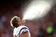 SAN FRANCISCO, CA - OCTOBER 06: J.J. Watt #99 of the Houston Texans spits water into the air before their game against the San Francisco 49ers at Candlestick Park on October 6, 2013 in San Francisco, California. (Photo by Ezra Shaw/Getty Images)