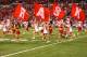 Dec 1, 2012; Indianapolis, IN, USA; Nebraska Cornhusker cheerleaders run onto the field carrying flags during player introductions before playing against the Wisconsin Badgers during the Big Ten championship game at Lucas Oil Stadium. Mandatory Credit: Brian Spurlock-USA TODAY Sports