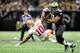 NEW ORLEANS, LA - NOVEMBER 25: Kyle Williams #10 of the San Francisco 49ers is knocked down by Jonathan Vilma #51 of the New Orleans Saints during a game at the Mercedes-Benz Superdome on November 25, 2012 in New Orleans, Louisiana. (Photo by Stacy Revere/Getty Images)