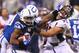 INDIANAPOLIS, IN - OCTOBER 20: Trent Richardson #34 of the Indianapolis Colts looks to escape a tackle by Derek Wolfe #95 of the Denver Broncos at Lucas Oil Stadium on October 20, 2013 in Indianapolis, Indiana. The Colts beat the Broncos 39-33. (Photo by Dilip Vishwanat/Getty Images)