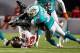 MIAMI GARDENS, FL - AUGUST 24: Receiver Mike Williams #19 of the Tampa Bay Buccaneers fumbles in front of Chris Clemons #30 of the Miami Dolphins at Sun Life Stadium on August 24, 2013 in Miami Gardens, Florida. (Photo by Marc Serota/Getty Images)