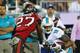 TAMPA, FL - NOVEMBER 11: Rishard Matthews #18 of the Miami Dolphins tries to break the tackle of Johnthan Banks #27 of the Tampa Bay Buccaneers in the first half at Raymond James Stadium on November 11, 2013 in Tampa, Florida. (Photo by Mike Ehrmann/Getty Images)
