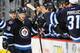 WINNIPEG, MB - NOVEMBER 4: Bryan Little #18 of the Winnipeg Jets celebrates his first period goal against the Detroit Red Wings with teammates at the bench at the MTS Centre on November 4, 2013 in Winnipeg, Manitoba, Canada. (Photo by Jonathan Kozub/NHLI via Getty Images)