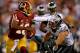 LANDOVER, MD - SEPTEMBER 09: Quarterback Robert Griffin III #10 of the Washington Redskins stiff arms linebacker Connor Barwin #98 of the Philadelphia Eagles in the third quarter at FedExField on September 9, 2013 in Landover, Maryland. The Philadelphia Eagles won, 33-27. (Photo by Patrick Smith/Getty Images)