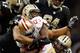 NEW ORLEANS, LA - NOVEMBER 25: Frank Gore #21 of the San Francisco 49ers is tackled by Will Smith #91 of the New Orleans Saints at The Mercedes-Benz Superdome on November 25, 2012 in New Orleans, Louisiana. The 49ers defeated the Saints 31-21. (Photo by Chris Graythen/Getty Images)