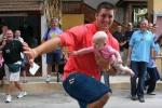 Tebow Does the Heisman While Holding Baby