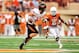 AUSTIN, TX - NOVEMBER 16: Quandre Diggs #6 of the Texas Longhorns pursues Charlie Moore #17 of the Oklahoma State Cowboys during a game at Darrell K Royal-Texas Memorial Stadium on November 16, 2013 in Austin, Texas. (Photo by Stacy Revere/Getty Images)