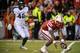 LINCOLN, NE - NOVEMBER 16: Quarterback Tommy Armstrong Jr. #4 of the Nebraska Cornhuskers picks up his fumble in front of defensive end Denzel Drone #42 of the Michigan State Spartans during their game at Memorial Stadium on November 16, 2013 in Lincoln, Nebraska. (Photo by Eric Francis/Getty Images)