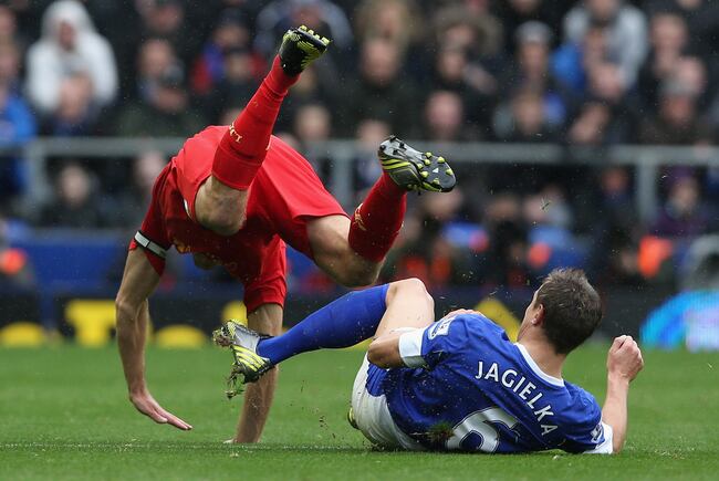 Hi-res-154868855-steven-gerrard-of-liverpool-is-brought-down-by-phil_crop_north