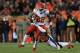 DENVER, CO - NOVEMBER 17: Dwayne Bowe #82 of the Kansas City Chiefs tries to break the tackle of Chris Harris #25 of the Denver Broncos after a first down reception in the first half at Sports Authority Field at Mile High on November 17, 2013 in Denver, Colorado. (Photo by Doug Pensinger/Getty Images)