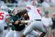EAST LANSING, MI - SEPTEMBER 29: Marcus Rush #44 of the Michigan State Spartans pulls down Braxton Miller #5 of the Ohio State Buckeyes during a second quarter play at Spartan Stadium on September 29, 2012 in East Lansing, Michigan. (Photo by Gregory Shamus/Getty Images)