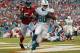 Sep 22, 2013; Miami Gardens, FL, USA; Miami Dolphins tight end Dion Sims (80) catches a touchdown pass as Atlanta Falcons outside linebacker Stephen Nicholas (54) looks on in the second half at Sun Life Stadium. Miami won 27-23. Mandatory Credit: Robert Mayer-USA TODAY Sports