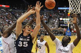 Hi-res-158576760-erik-stenger-of-the-xavier-musketeers-is-defended-by_crop_north