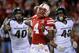 LINCOLN, NE - NOVEMBER 16: Quarterback Tommy Armstrong Jr. #4 of the Nebraska Cornhuskers runs from linebacker Ed Davis #43 of the Michigan State Spartans and linebacker Max Bullough #40 of the Michigan State Spartans during their game at Memorial Stadium on November 16, 2013 in Lincoln, Nebraska. (Photo by Eric Francis/Getty Images)
