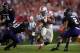 Oct 5, 2013; Evanston, IL, USA; Ohio State Buckeyes running back Carlos Hyde (34) runs between Northwestern Wildcats safety Traveon Henry (10) and cornerback Dwight White (2) during the third quarter at Ryan Field. Ohio State won 40-30. Mandatory Credit: Jerry Lai-USA TODAY Sports