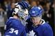 TORONTO, ON - NOVEMBER 16: James Reimer #34 and Jake Gardiner #51 of the Toronto Maple Leafs celebrate the teams win over the Buffalo Sabres during NHL game action November 16, 2013 at the Air Canada Centre in Toronto, Ontario, Canada. (Photo by Graig Abel/NHLI via Getty Images)