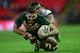 LONDON, ENGLAND - NOVEMBER 23: Greg Inglis of Australia is tackled by Eloni Vunakece of Fiji during the Rugby League World Cup Semi Final match between Australia and Fiji at Wembley Stadium on November 23, 2013 in London, England. (Photo by Jamie McDonald/Getty Images)