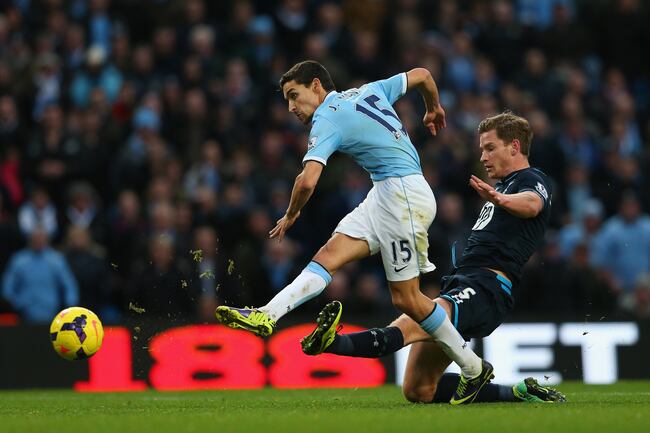 Hi-res-451692971-jesus-navas-of-manchester-city-beats-a-tackle-from-jan_crop_north