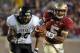 Nov 23, 2013; Tallahassee, FL, USA; Florida State Seminoles quarterback Jameis Winston (5) runs away from pressure by Idaho Vandals defensive end Maxx Forde (40) during the second half at Doak Campbell Stadium. Mandatory Credit: Melina Vastola-USA TODAY Sports