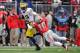 COLUMBUS, OH - NOVEMBER 24: Quarterback Devin Gardner #12 of the Michigan Wolverines tries to elude the tackle attempt of Ryan Shazier #10 of the Ohio State Buckeyes at Ohio Stadium on November 24, 2012 in Columbus, Ohio. (Photo by Jamie Sabau/Getty Images)