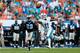 MIAMI GARDENS, FL - NOVEMBER 24: Mike Wallace #11 of the Miami Dolphins stretches to try and make a catch as Drayton Florence #29 of the Carolina Panthers looks on at Sun Life Stadium on November 24, 2013 in Miami Gardens, Florida. (Photo by Chris Trotman/Getty Images)