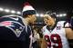 FOXBORO, MA - JANUARY 13: Tom Brady #12 of the New England Patriots greets J.J. Watt #99 of the Houston Texans after the 2013 AFC Divisional Playoffs game at Gillette Stadium on January 13, 2013 in Foxboro, Massachusetts. (Photo by Elsa/Getty Images)