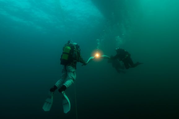 Olympic Flame Carried Underwater in World's Deepest Lake